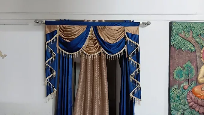 Curtain drapes installed by M R Venetians in a residential living room